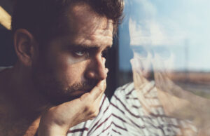 Man staring out window